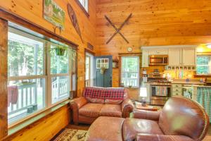 a living room with leather furniture in a cabin at The Locke-ness Pond Cabin in Chesterville! in Wilton