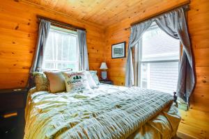 a bedroom with a bed and a window in a room at The Locke-ness Pond Cabin in Chesterville! in Wilton