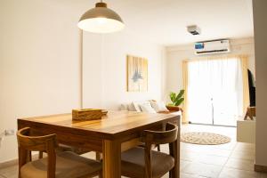 a dining room with a wooden table and chairs at Arrayanes 5 B in San Miguel de Tucumán