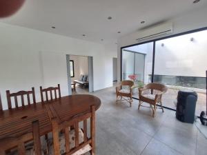 a living room with a wooden table and chairs at Muana Escobar in Belén de Escobar