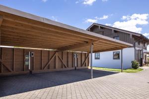 a large building with a large wooden roof at Mühlberger Hof in Petting