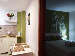 a bedroom with a bed and a desk in it at il Bamboo 1 in Taranto