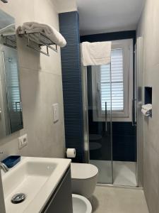 a bathroom with a sink and a toilet and a shower at Villa Mar Mediterraneo in Villasimius