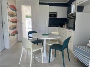 a kitchen and dining room with a table and chairs at Villa Mar Mediterraneo in Villasimius +27 photos