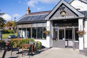 a building with a table and chairs in front of it at White Rabbit by Chef & Brewer Collection in Lyndhurst