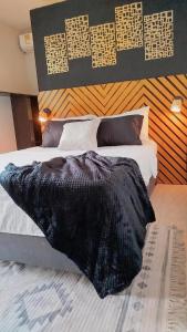 a black blanket laying on a bed in a bedroom at Hb4 Double Room with Private Bathroom and Balcony in Cartagena de Indias