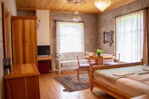 a bedroom with a bed and a living room at Lake Cildir Lodge in Çıldır