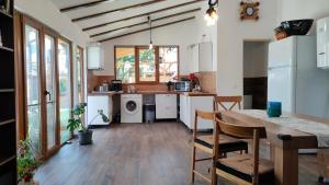 a kitchen with a table and a dining room at Casa Selera Rasnov in Râşnov