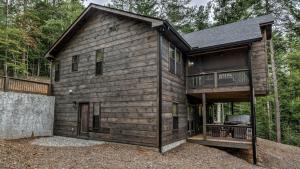 a log cabin with a grill in front of it at The Retreat at Laurel Creek in Blue Ridge