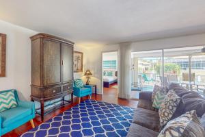 a living room with a couch and blue chairs at Marco Island Manor in Marco Island
