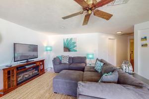 a living room with a couch and a flat screen tv at Marco Island Manor in Marco Island