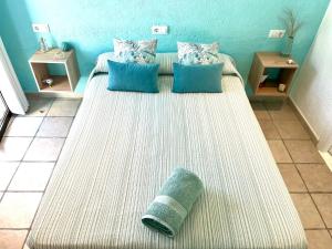 a large bed in a room with blue walls at La Puerta Azul in Jávea +15 photos