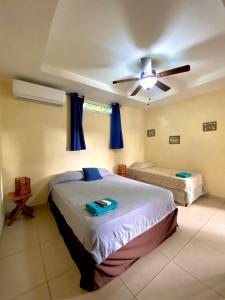 a bedroom with a bed and a ceiling fan at Casa Inti Guesthouse & Lodge in Managua +85 photos