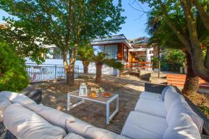 a couch and a table in front of a house at Villa Indipendente Panoramica, terrazze e giardino in Massa Lubrense