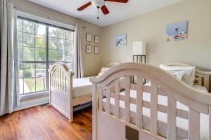 a bedroom with two cribs and a large window at Lakefront Home with Private Boat Dock on Lake Lanier in Murrayville