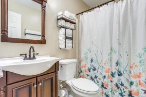 a bathroom with a sink and a toilet and a shower curtain at Lakefront Home with Private Boat Dock on Lake Lanier in Murrayville +31 photos