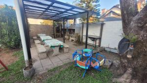 a patio with a table and chairs under awning at El Ámbar in Colón