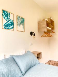 a bedroom with a bed and two pictures on the wall at Verenna Departamentos en Mar del Plata in Mar del Plata