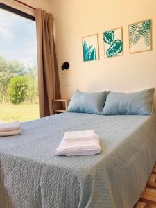 a bedroom with a bed with two towels on it at Verenna Departamentos en Mar del Plata in Mar del Plata