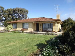 a house with a lawn in front of it at Kirazz Holiday Homes in Kingscote