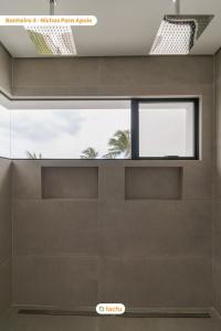 a pivot door in a house with a window at Vila Juriti: Luxo Frente Mar no melhor do Fortim in Fortim