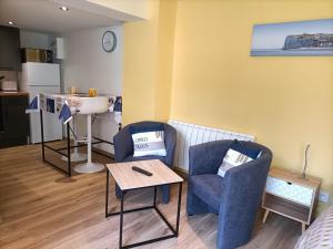 a living room with two chairs and a table at Studio à 2 pas de la plage avec terrasse in Mers-les-Bains