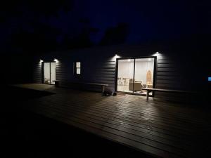 a building with a large window on a deck at night at Nina casa de playa in Balneario Buenos Aires
