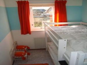 a bedroom with a bunk bed and a window at Bungalow in Breskens near the Beach in Breskens +30 photos