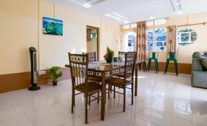 a dining room and living room with a table and chairs at Sunset Bliss Pereybere 2 in Pereybere +12 photos