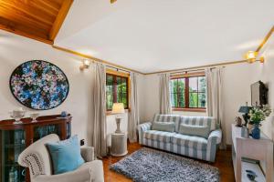 a living room with two chairs and a couch at Kew Cottage in Greytown