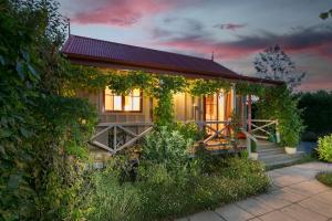 a house with vines growing on the side of it at Kew Cottage in Greytown