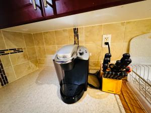 a coffee maker in the corner of a room at Cozy Walkout Basement with Tranquility in Toronto