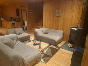a living room with two beds and a tv at La gran escapada in Navidad