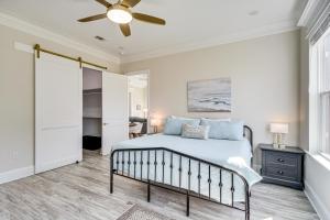 a bedroom with a bed and a ceiling fan at Steps to Beach Modern Gulfport Getaway! in Gulfport