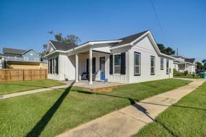 a white house with a lawn in front of it at Steps to Beach Modern Gulfport Getaway! in Gulfport
