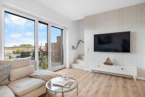 Μια τηλεόραση ή/και κέντρο ψυχαγωγίας στο Ferienhaus Strandhuus