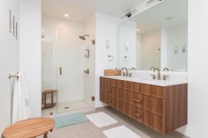 a bathroom with a large sink and a shower at Back-Bay 2BR Condo w Roof top Gym Parking in Boston +51 photos