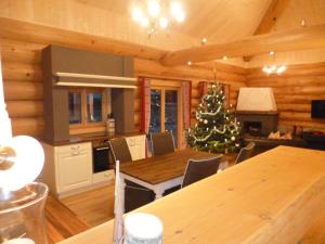 a kitchen and dining room with a christmas tree in it at Adlernest Lechtal in Bach