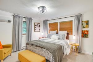 ein Schlafzimmer mit einem großen Bett und einem gelben Stuhl in der Unterkunft Serene Holmes Cottage Near Lakes and Trails! in Pawling + 16 Fotos