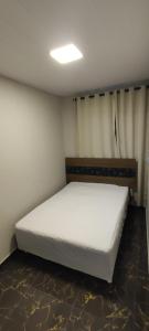 a bedroom with a white bed in a room at Rancho do Vale in Carlópolis +28 photos