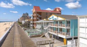 a row of hotels on the beach next to a boardwalk at Eden Roc Ocean Front in Ocean City