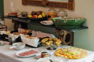 a table topped with plates of food on a table at Solar dos Cantos Botanic House & Garden in Ponta Delgada