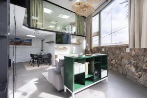 a living room and dining room with a green table at OkStay Loft Victoria Top Tenerife in La Victoria de Acentejo +16 photos