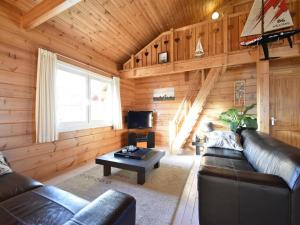 a living room with a couch and a table at ZeeWolf in Sint Annaland