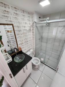 a bathroom with a shower and a sink and a toilet at AP BOHO 1010 Brás - Piscina Aquecida, WiFi, Academia, Cama Casal box e colchão extra solteiro in Sao Paulo