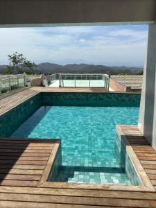 a swimming pool with a view of the mountains at Mansão da Montanha in Niterói