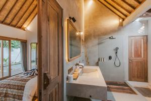 a bathroom with a bed and a sink in a room at Villa Diamond Lembongan in Nusa Lembongan +17 photos
