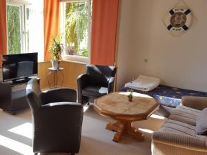 a living room with a couch and a table at Holiday apartment in Waren Müritz in Waren