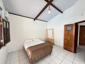 Postel nebo postele na pokoji v ubytování Casa Tropical Arraial D' Ajuda