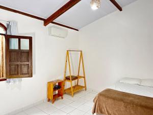 Postel nebo postele na pokoji v ubytování Casa Tropical Arraial D' Ajuda